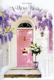 This image shows a front doorway that feels as though it belongs on a quiet Raynes Park lane, where gardens and terraces are lovingly tended. The entrance is defined by a pale pink door with a matte, chalky finish, set within whitewashed walls that lend the space a bright, clean backdrop. Overhead, mature wisteria drapes dramatically, its clusters of lavender blossoms falling in loose, fragrant cascades that frame the door like a natural garland, much like the floral displays seen winding over fences along Coombe Lane. The wisteria's delicate leaves add feathery texture, and the shadows they cast flicker gently across the plaster. At the doorstep, a sturdy grey metal bucket holds a generous arrangement of creamy white and soft ivory roses. Each rose is plush and full-petalled, arranged in a dense, rounded mass that looks both luxurious and inviting, with tendrils of gentle green foliage threaded throughout to soften the lines. A blush-pink satin ribbon hugs the bucket's base, tied in an elegant bow whose sheen catches the daylight and subtly echoes the door's colour. The light in the scene is soft and warm, perhaps early evening light drifting across from a nearby garden, giving the petals a faint glow and creating a sense of depth and quiet intimacy. The overall impression is one of calm celebration - flowers set carefully outside a newly claimed Raynes Park home, ready to greet the homeowners as they return from a walk through Wimbledon Common or a stop at the local shops. It's a visual expression of welcome, joy, and the promise of many happy moments to come behind that pink door.